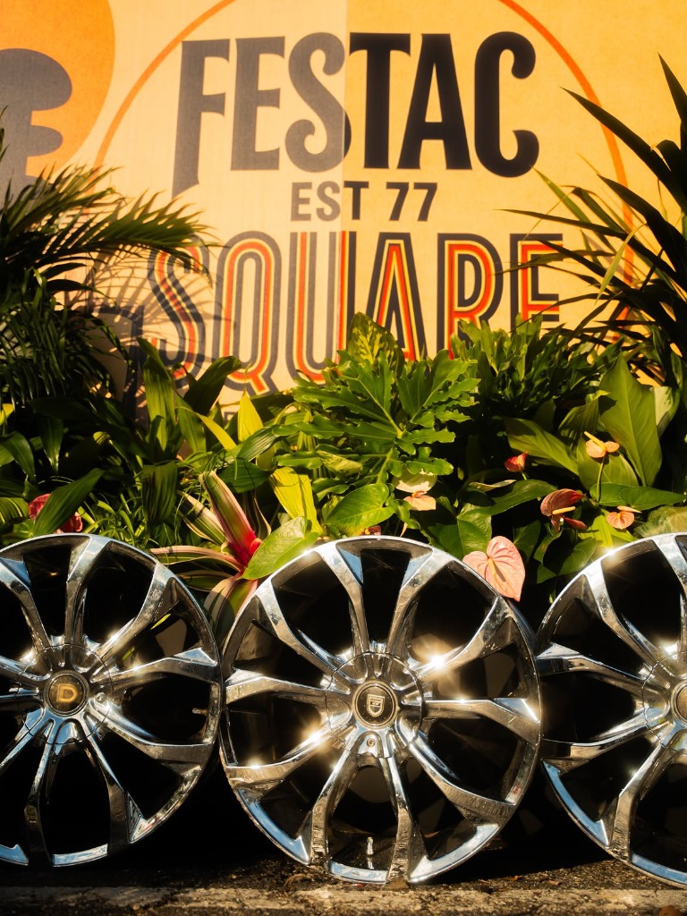 Festac Square activation — branded sign and chrome rims at the entry